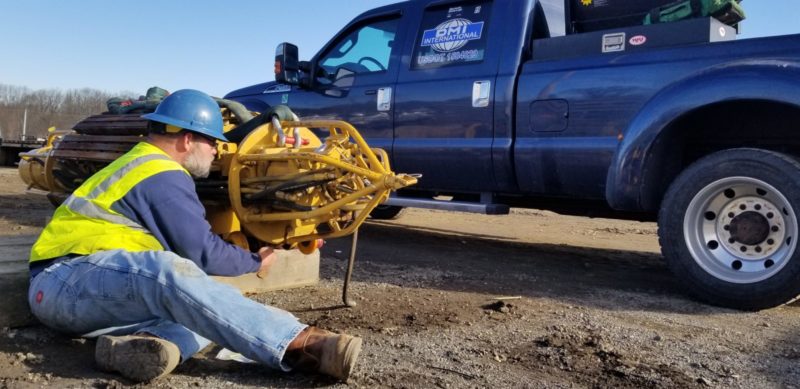 DMI International employee servicing pipeline bending equipment for a customer